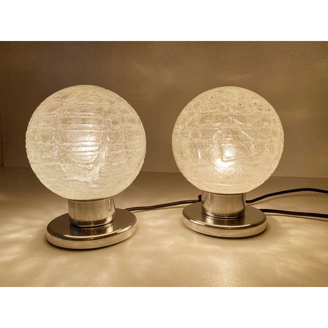 Pair of vintage mid century table lamps by doria germany, featuring lava crystal globe glass shade on chrome base...