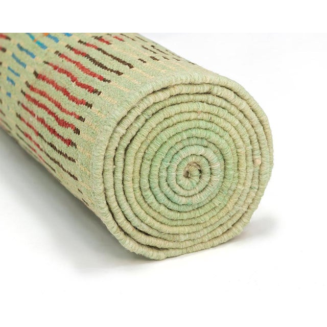 Make a bold statement in your hallway or entryway with this exceptional hand-knotted Moroccan wool runner rug. Measuring...