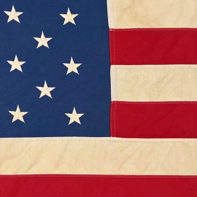 This vintage American flag is made from a cotton cloth, with fully sewn stripes and embroidered stars. Please note overall...