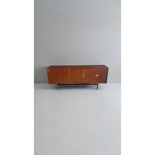 Teak sideboard designed by Edmondo Palutari for Dassi in the 1960s. The sideboard has two lockable doors and an internal...