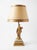 A striking pair of vintage figural table lamps featuring classically draped female forms rendered in gilded brass, mounted...