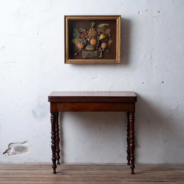 A French flip top game table, late Charles X period. Original decorated felt play mat. 33 inches wide by 16 ½ inches deep...