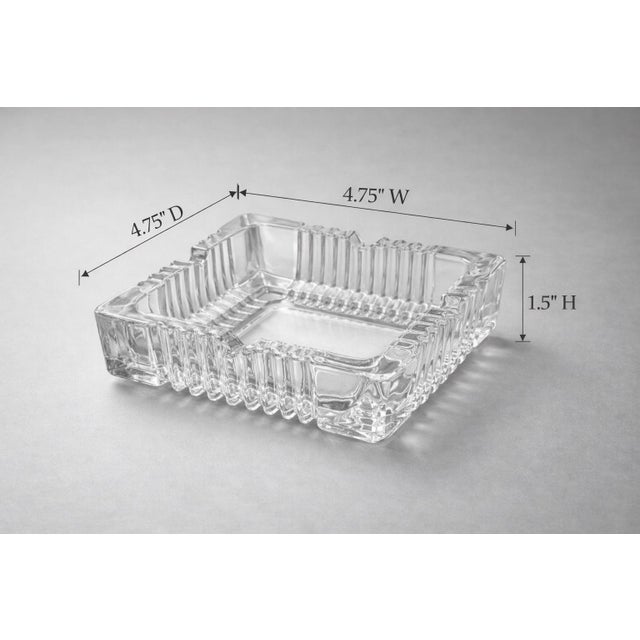 A heavy, square pressed glass ashtray with bold ribbed geometry and strong Art Deco revival lines. Perfect as a desk...
