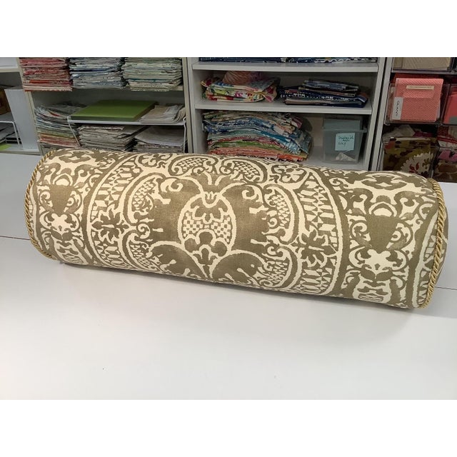 Gold and cream bolster pillow in Quadrille fabric with down insert and gold cording.