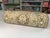 Gold and cream bolster pillow in Quadrille fabric with down insert and gold cording.