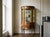 A 19th century French Louis XIV style Vernis Martin vitrine with hand painted panels, cast bronze mounts and curved glass....