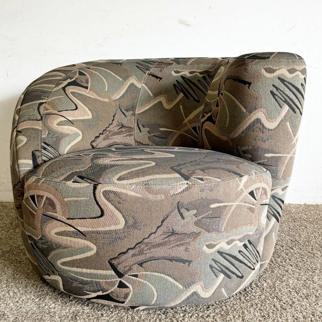 Embrace the boldness of postmodern design with this Nautilus “Camo” Swivel Barrel Chair. This chair features a distinctive...