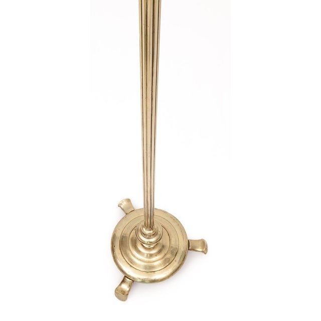 Modern brass floor lamp. Gadrooned foot. Circular plasticized lampshade with braids. Electricity redone. Circa 1950...