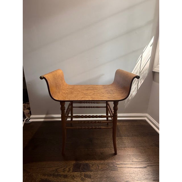 Vintage Mid-Century Modern wooden bench featuring a gracefully curved backrest and solid wood seat that functions as both...