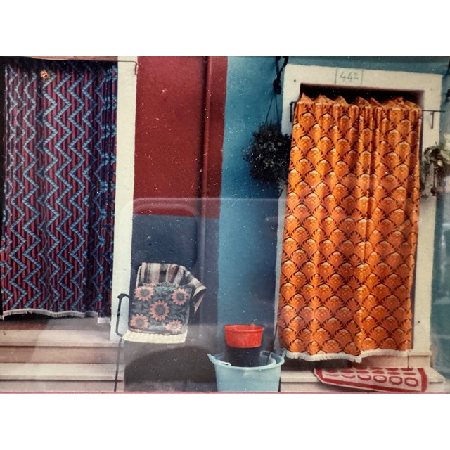 Colorful signed and dated 1983 artwork depicting two vividly painted doorways with patterned curtains, a chair, buckets...