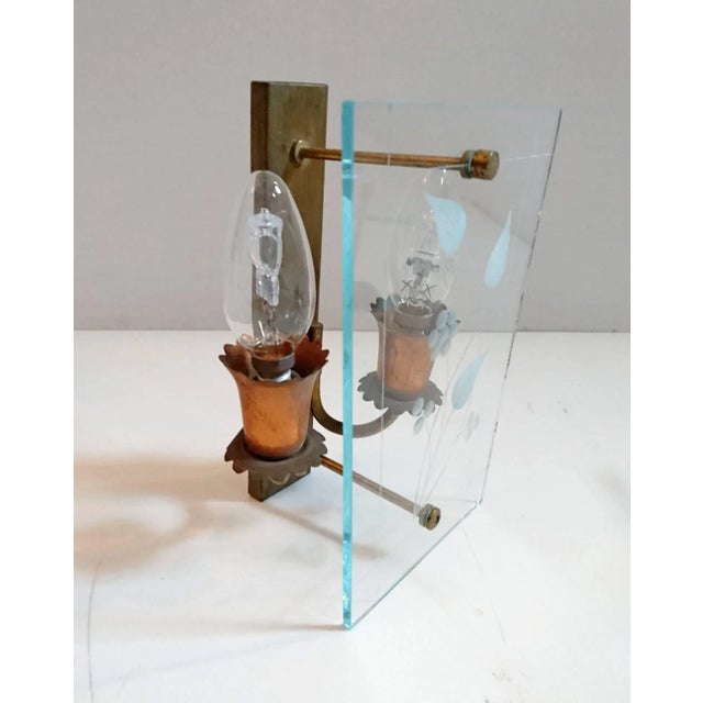 Wall sconces made in Italy in the 1950s in etched glass, copper and brass. With a dimmer switch these will spread a...