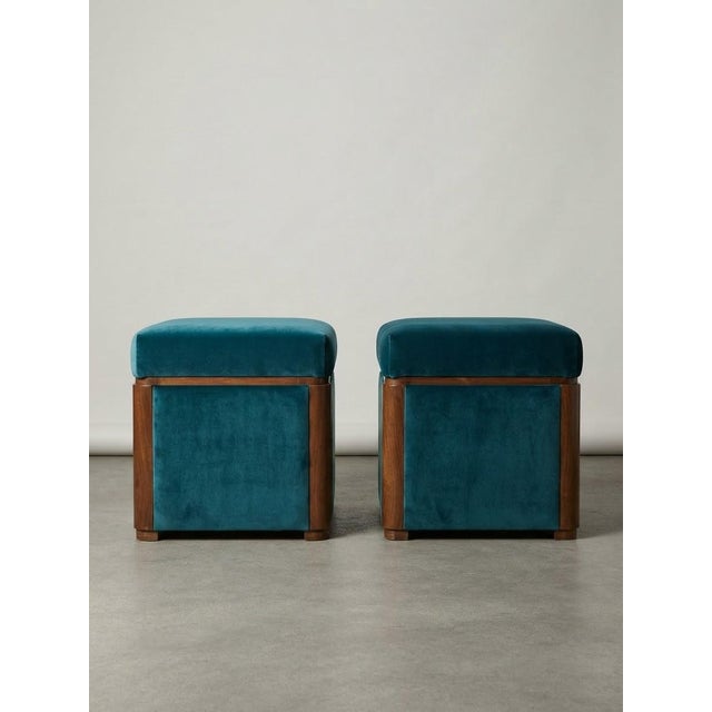 A stunning pair of fully refurbished Hungarian Art Deco ottomans, featuring pristine teal blue velvet upholstery encased...