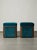 A stunning pair of fully refurbished Hungarian Art Deco ottomans, featuring pristine teal blue velvet upholstery encased...