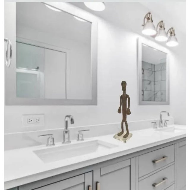 Wonderful standing man made out of handmade forged iron, mounted on a Lucite base. In the manner of the Dogan Tribe,...