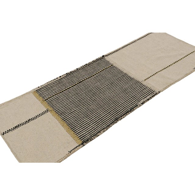 Handwoven in wool, a 2x6 runner Kilim in black and beige/brown tones, from a bold new line of contemporary flatweaves,...