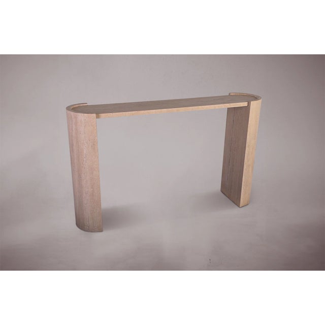 Introducing our exquisite travertine console table with a unique D-shaped design, featuring two elegantly curved legs....