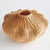 This palm rattan woven vase features an undulating shape wrapped around a rigid wire frame. It takes a masterful weaver to...