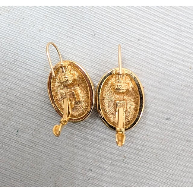 1980s goldtone oval domed with checkerboard pattern on a wire drop pierced earrings. Marked "©MONET" on the backs near the...