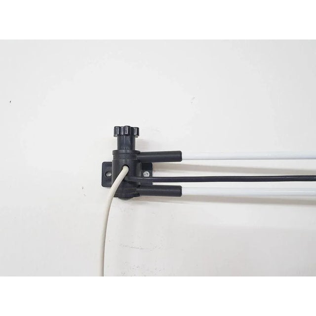 Metal and plastic adjustable wall light in black and white Eduardo Albors This piece has an attribution mark, I am sure...