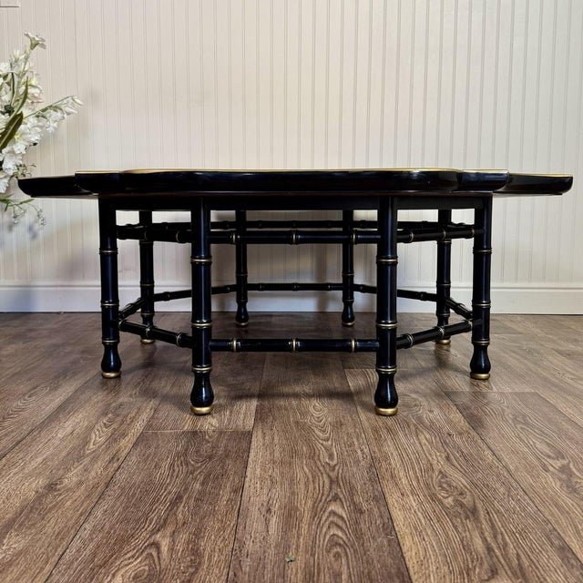Vintage Hollywood Regency chinoiserie coffee or cocktail table with a pie-crust scalloped edge, a black lacquer finish,...