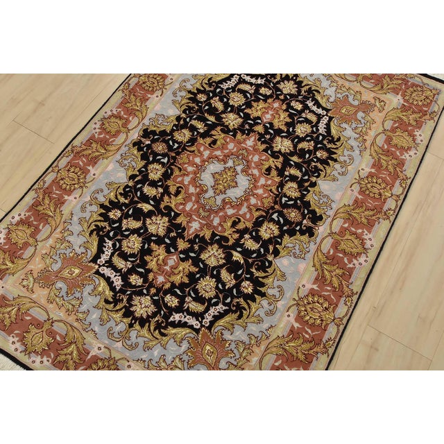 An authentic vintage traditional Tabriz rug hand-knotted with fine wool and silk highlights, using natural dyes. This...