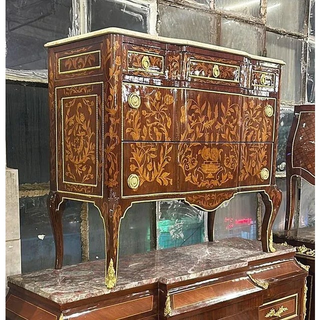 Magnificent French marquetry commode with marble inlays Louis XVI style. Stunning French commode. Has a beautiful gold...