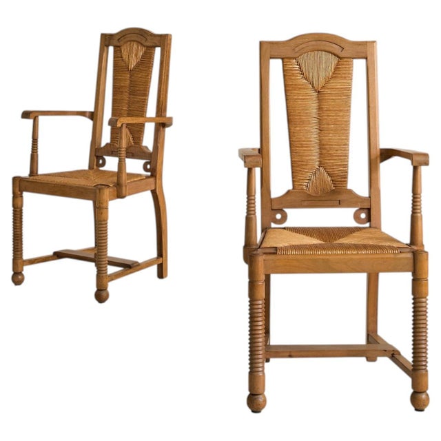 A French armchair from the 1950s, created in the manner of Francis Jourdain. Crafted from solid wood with a handwoven rush...