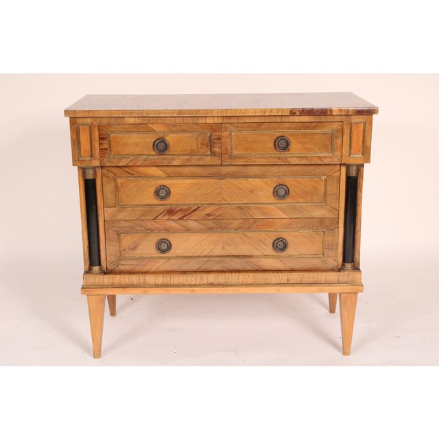 Italian neo-classical style walnut and fruitwood chest of drawers, circa 1960. With a rectangular top, two side by side...