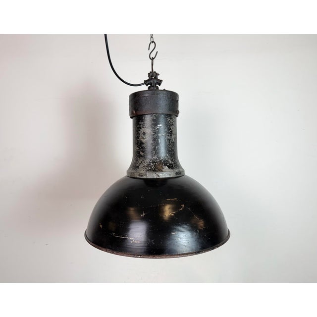 Industrial black pendant light made by elektrosvit in former czechoslovakia in 1951. White interior. Cast iron top. Two...