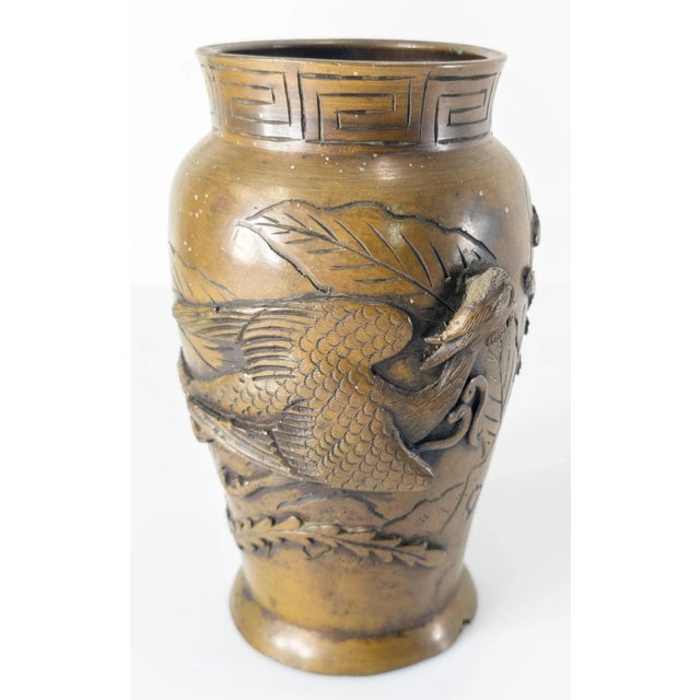 We are selling this 20th century Chinese or Japanese cast bronze vase with raised phoenix decoration and mark on the...