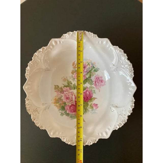 A beautiful German porcelain large bowl with victorian romantic design filled with pink roses, circa early-20th century,...