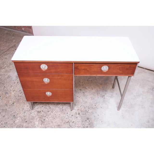 1960s single pedestal desk by Raymond Loewy for Hill-Rom composed of a walnut and brushed metal frame with inset brushed...