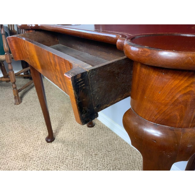George II period mahogany fold-over card table with a hidden drawer on the front frieze, the rectangular top with...