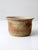 Vintage handmade studio pottery bowl with a softly flared rim and a grounded, rounded form. The glaze settles into warm...