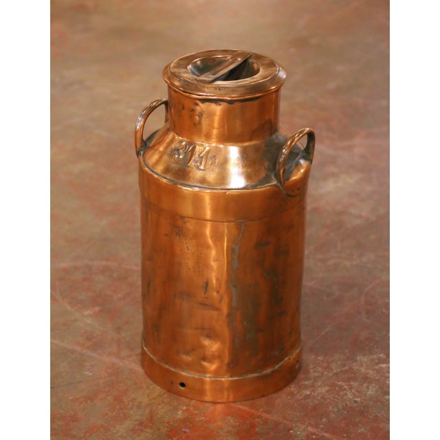 This substantial antique copper milk can was crafted in France circa 1890. Executed in traditional cylindrical dairy form,...