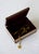A wooden jewelry and keepsake box featuring a hand-painted miniature polo scene, framed by geometric marquetry borders....