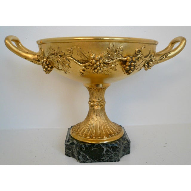 This finely detailed gilt bronze compote features a border of vintage motif including grapes and grape leaves. The compote...