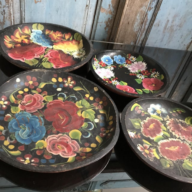 A beautifully crafted Mexican wooden plate featuring a black base and vibrant hand-painted flowers. This piece combines...