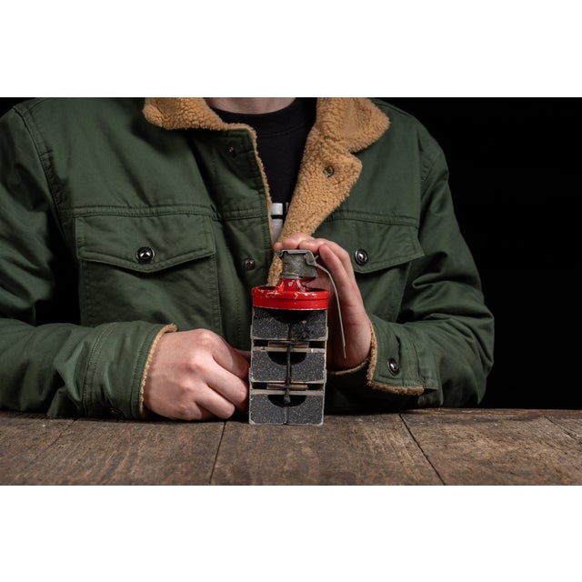 Mid-20th-century cutaway demonstrator illustrating the internal construction of a pressurized gas canister. The metal body...