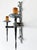 A wrought iron double wall sconce in arts & crafts style, most likely mid-20th century, with hand-forged decorative...