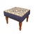 Meticulously handcrafted in the United Kingdom, this upholstered stool boasts classic studding and hand-polished solid...