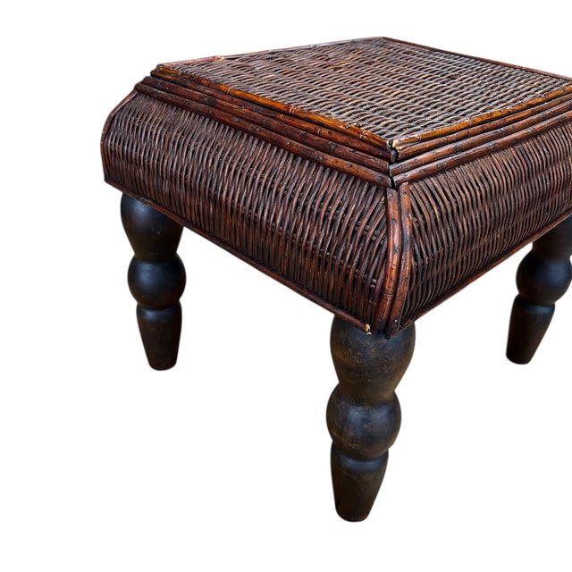 British colonial style burnt bamboo and woven rattan footstool with dark turned legs. Some imperfections and minor repairs...