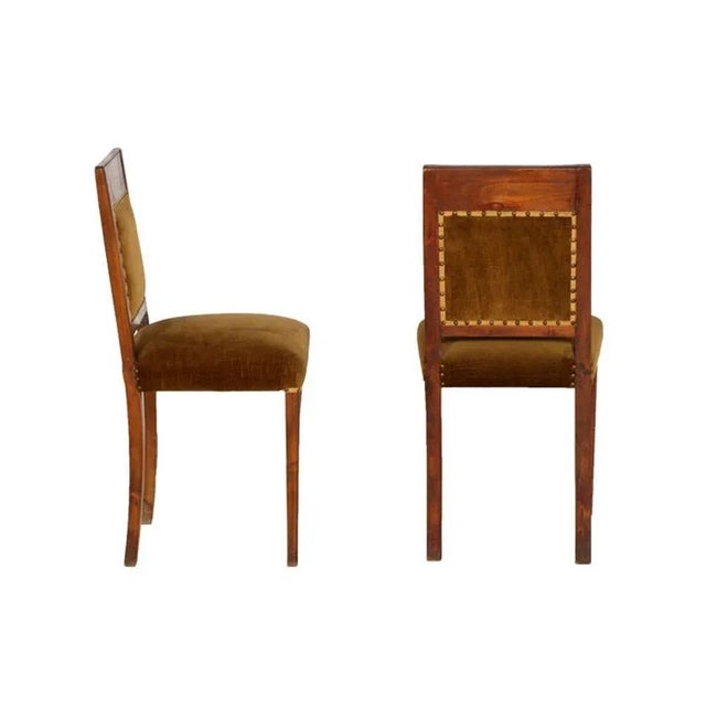 These Art Deco side chairs are made of walnut and feature velvet upholstery.