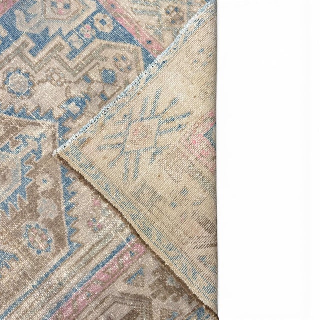 An antique hand-knotted rug with a beautifully drawn geometric medallion combining tribal-inspired motifs and stylized...