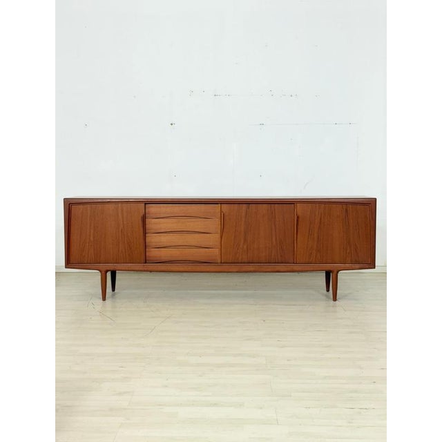 Stylish mid-century sideboard made of high-quality teak, designed by Gunni Omann and manufactured by Axel Christiansen...