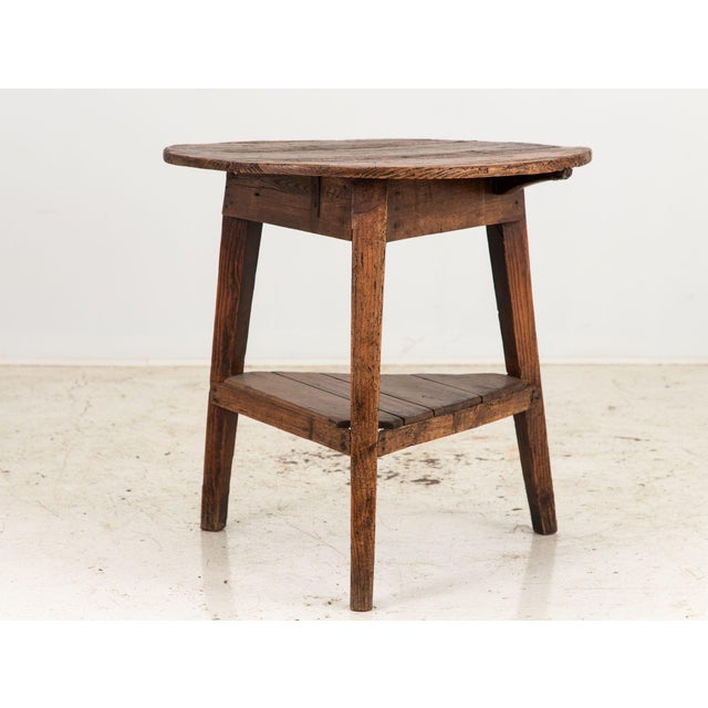 This charming 19th-century fruitwood English cricket or pub table exudes antique appeal. Its round top is supported by...