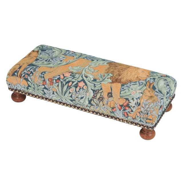 Meticulously handcrafted in the United Kingdom, this upholstered stool boasts classic studding and hand-polished solid...