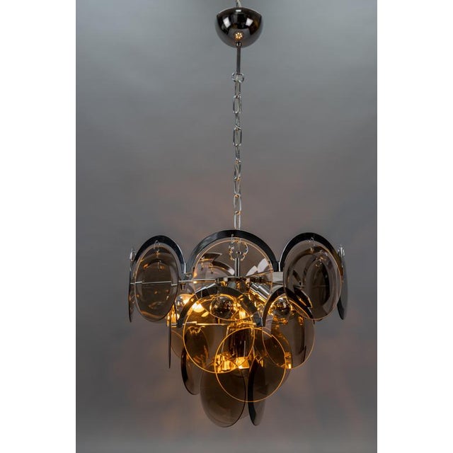 Smoked glass and chromed metal seven-light pendant chandelier, Italy, circa the 1970s, attributed to Gino Vistosi. This...