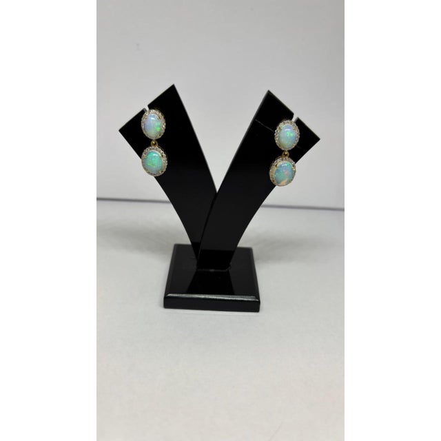 Gemstone details Diamond weight: 0.53 cts Opal weight: 4.44 cts 14K gold Gross weight: 4.410 grams Gold weight: 3.41 grams...