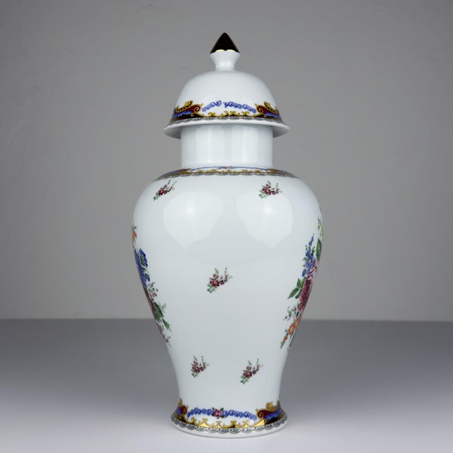 Vintage porcelain ginger jar with flower decorations made in Limoges, France in the 1970s. Hand-painted and gold borders....